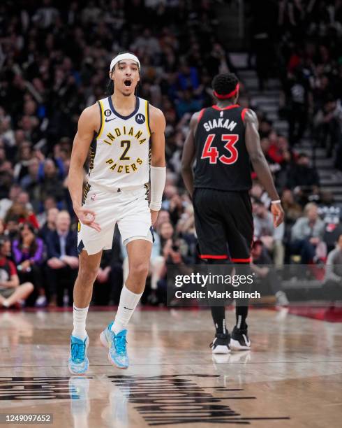 Andrew Nembhard of the Indiana Pacers celebrates his three point shot against the Toronto Raptors late in the second half of their basketball game at...