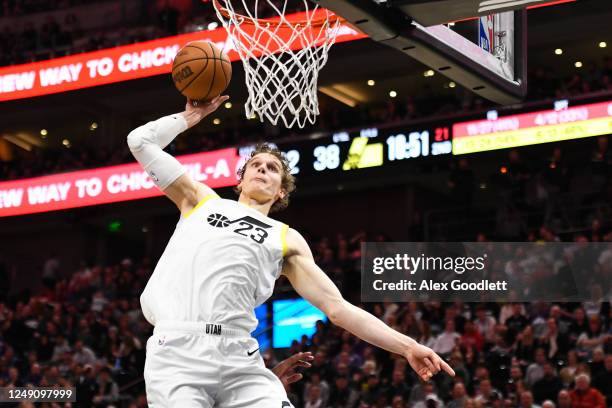 Lauri Markkanen of the Utah Jazz dunks over Cam Reddish of the Portland Trail Blazers during the first half at Vivint Arena on March 22, 2023 in Salt...