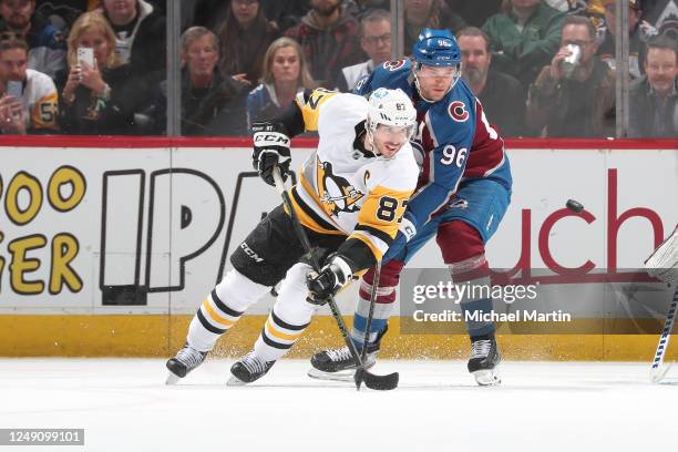 Mikko Rantanen of the Colorado Avalanche defends against Sidney Crosby of the Pittsburgh Penguins at Ball Arena on March 22, 2023 in Denver,...