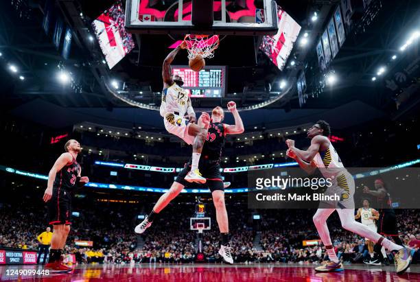 Oshae Brissett of the Indiana Pacers dunks against Jakob Poeltl of the Toronto Raptors during the second half of their basketball game at the...