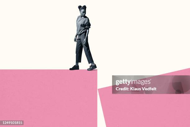 young woman walking while looking back at block - looking to the past stock pictures, royalty-free photos & images