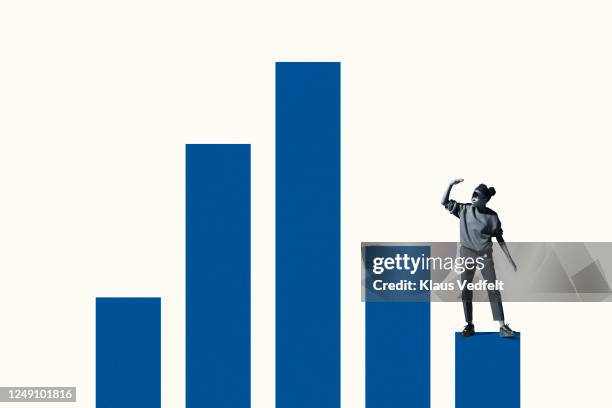 woman shielding eyes while standing on bar graph - bias stock pictures, royalty-free photos & images