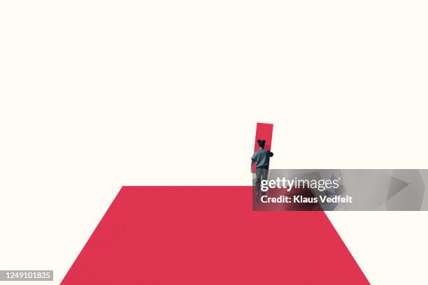 woman carrying pink block while walking on ramp - woman walking studio back stock pictures, royalty-free photos & images