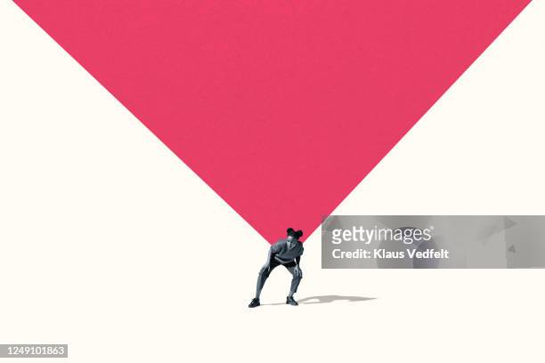 young woman carrying large pink triangle - voll geladen stock-fotos und bilder