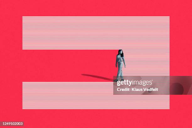 young woman walking on striped studio backdrop - rotation concept stock pictures, royalty-free photos & images