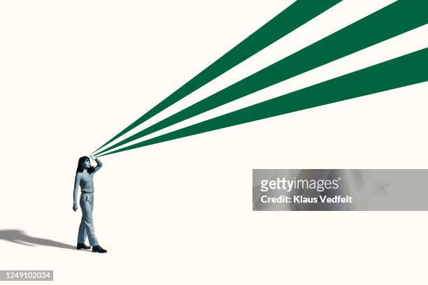 young woman shielding eyes with green rays - initiative stock pictures, royalty-free photos & images