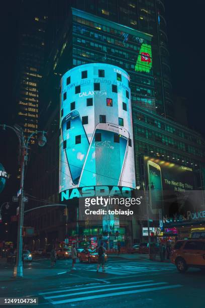 nasdaq stock exchange billboard at times square in new york city - nasdaq stock pictures, royalty-free photos & images