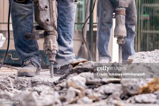 manual worker operating jackhammer. - demolition expert stock pictures, royalty-free photos & images