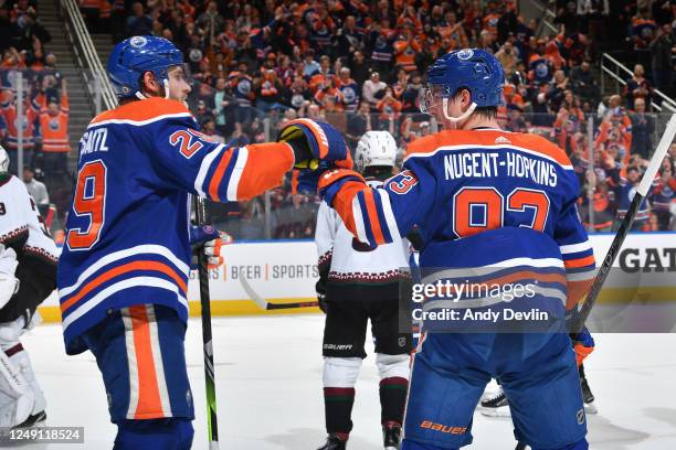 Ryan Nugent-Hopkins of the Edmonton Oilers celebrates after his second period goal against the Arizona Coyotes with Leon Draisaitl on March 22, 2023...