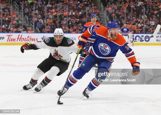 Mattias Ekholm of the Edmonton Oilers controls the puck against Nick Schmaltz of the Arizona Coyotes in the second period at Rogers Place on March...