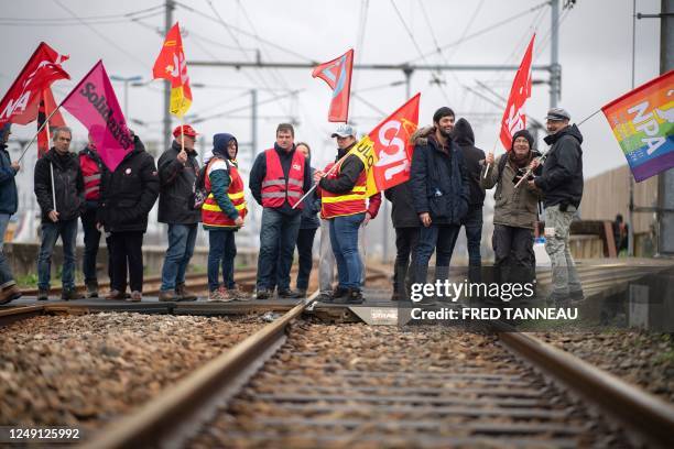 Protestors from French unions block the railway station on a national action day, a week after the government pushed a pensions reform through...