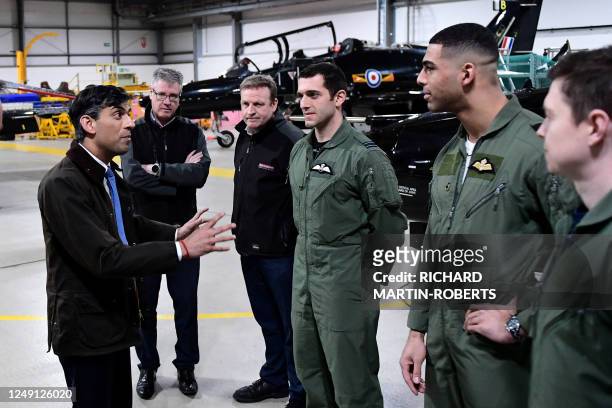 Britain's Prime Minister Rishi Sunak talks to trainee pilots during a visit to RAF Valley in Anglesey, north Wales on March 22, 2023.