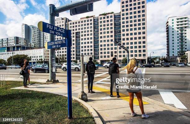 Florida International University students wait to cross Southwest Eighth Street at 109th Avenue, where a pedestrian bridge collapsed while under...