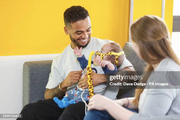 Singer and actor Aston Merrygold with Baby Ezra and his mother Ruth as he surprises families, as part of a special 'Masked Singer' themed event...