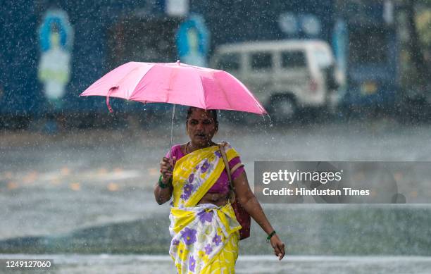 Heavy unseasonal rain takes people by surprise, at Sion, on March 21, 2023 in Mumbai, India.