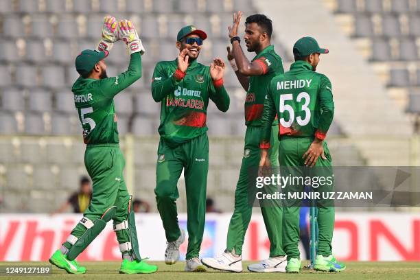 Bangladesh's Ebadot Hossain celebrates with teammates after taking the wicket of Ireland's Lorcan Tucker during the third and final one-day...