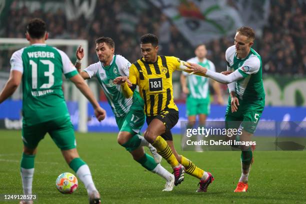 Abdenego Nankishi of SV Werder Bremen, Jude Bellingham of Borussia Dortmund and Amos Pieper of SV Werder Bremen battle for the Ball during the...