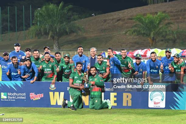 Bangladesh's players pose with the trophy after winning the series at the end of the third and final one-day international cricket match between...