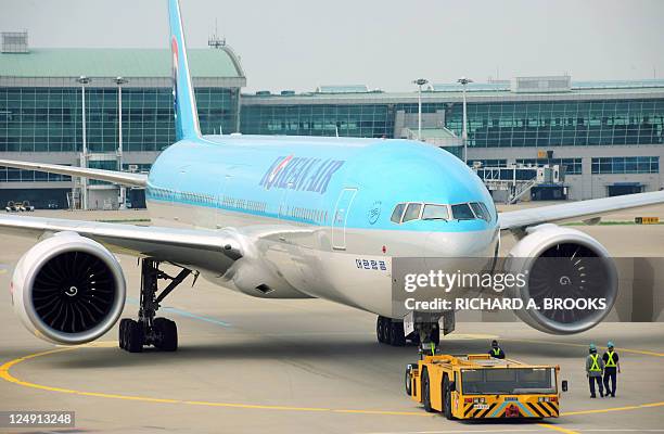 This photo taken on August 9, 2011 shows a Korean Air passenger jet leaving the gate before take off at Incheon International Airport, outside the...