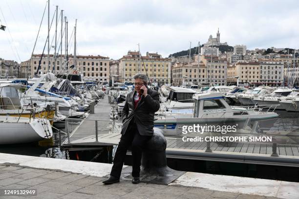 French leftist party La France Insoumise leader Jean-Luc Melenchon speaks on mobile phone prior to the start of a demonstration, a week after the...