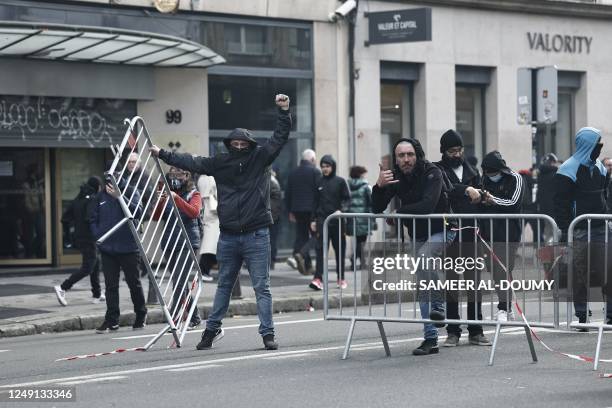 Protesters install fences during a demonstration on a national action day, a week after the government pushed a pensions reform through parliament...