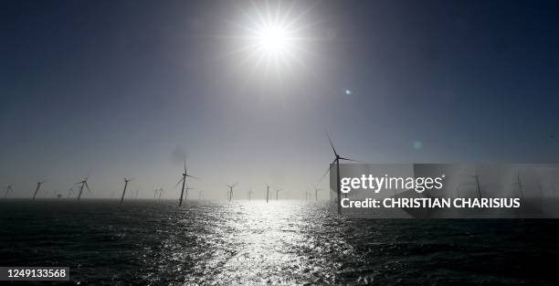 Wind turbines are pictured as the sun shines during the installation of the RWE Offshore Wind farm Kaskasi off the coast of the north German Island...