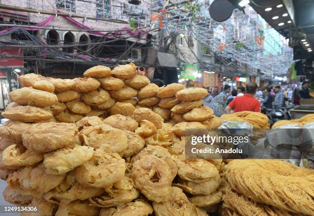 Muslims in India purchase their needs in a bazaar before the first fast-breaking evening meal of Ramadan, in New Delhi on March 23, 2023.