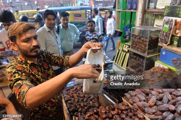 Muslims in India purchase their needs in a bazaar before the first fast-breaking evening meal of Ramadan, in New Delhi on March 23, 2023.