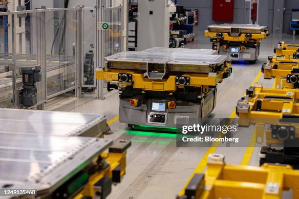 Automated guided vehicles transport the lower housing sections of electric vehicle batteries at an Accumotive GmbH plant, a subsidiary of...