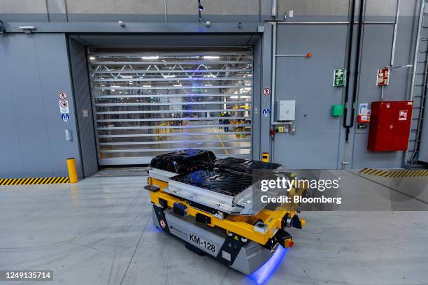 An automated guided vehicle transports finished electric vehicle batteries to the logistics center at an Accumotive GmbH plant, a subsidiary of...