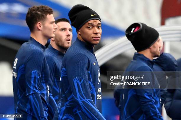 France's forward Kylian Mbappe and teammates arrive for a training session at the Stade de France in Saint-Denis, north of Paris on March 23 on the...
