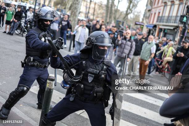 French Republican Security Corps police officers clash with protestors during a demonstration, a week after the government pushed a pensions reform...