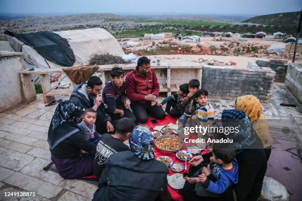 People, living in a tent camp, have fast-breaking dinner on the first day of Muslim's holy month Ramadan, in Idlib, Syria on March 23, 2023.