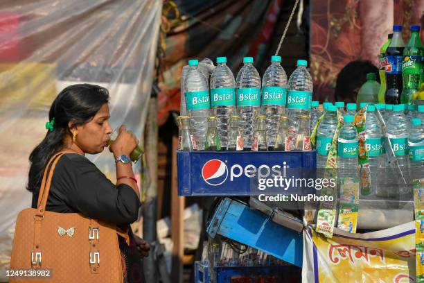 Lady is seen drinking juice at a roadside juice counter in Kolkata , India , on 23 March 2023 . India recorded the hottest February in last century ,...