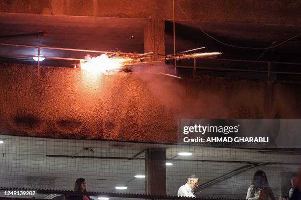 Fireworks are fired from a building towards protesters marching in a demonstration against the Israeli government's proposed judicial reform...