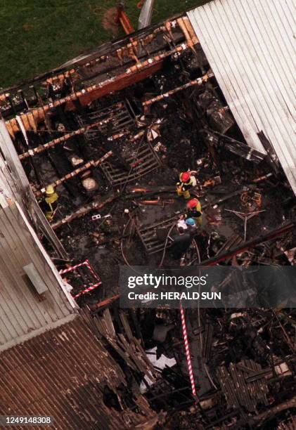 Firefighters shift through the rubble of the Kew Cottages in Melbourne 09 April to recover the bodies of nine mentally handicapped men who burnt to...