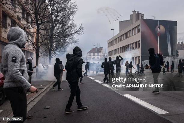 Protestors clash with police officers who threw tear gas grenades during a demonstration, a week after the government pushed a pensions reform...