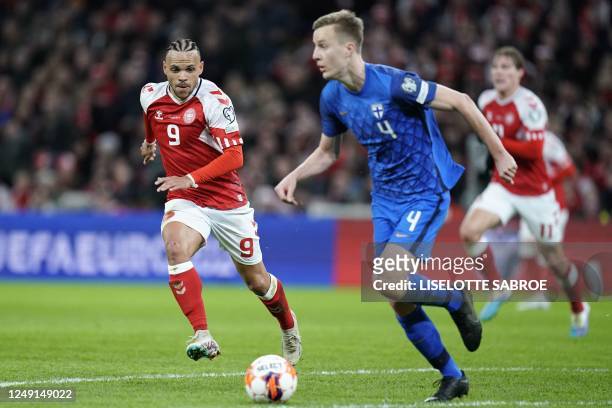 Denmark's forward Martin Braithwaite chases Finland's defender Robert Ivanov during the UEFA Euro 2024 Group H qualification football match Denmark v...