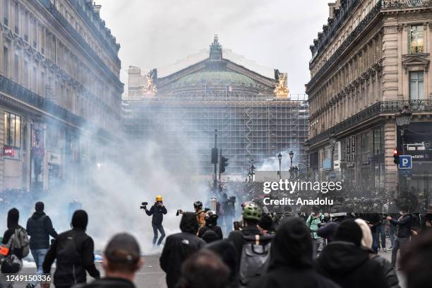 Riot police use tear gas on demonstrators during a protest against the government after pushing the pensions reform without a vote using article 49.3...