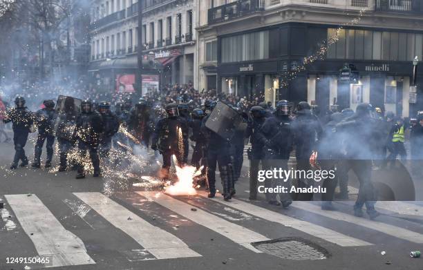 Riot police defend themselves during clashes during a protest against the government after pushing the pensions reform without a vote using article...