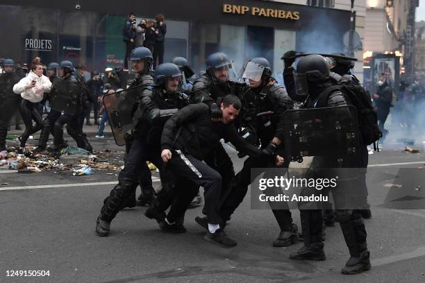 Riot police intervene with demonstrators during a protest against the government after pushing the pensions reform without a vote using article 49.3...