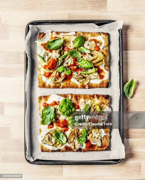 a tray of vegetarian homemade pizza on wooden background - vegetarian pizza stock pictures, royalty-free photos & images