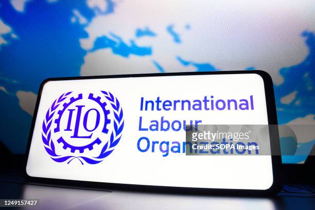In this photo illustration, the International Labour Organization logo seen displayed on a smartphone screen.