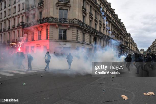 Riot police use tear gas on demonstrators during a protest against the government after pushing the pensions reform without a vote using article 49.3...