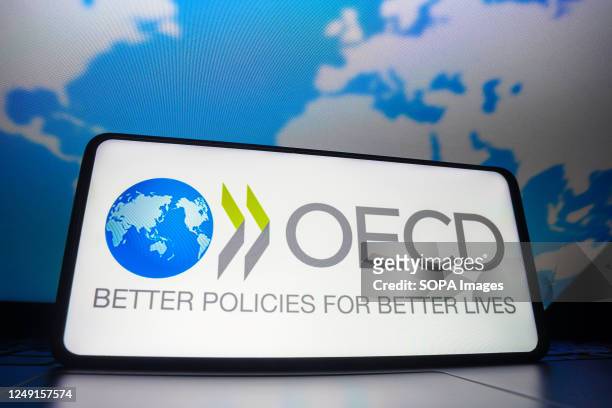 In this photo illustration, the Organization for Economic Co-operation and Development logo seen displayed on a smartphone screen.