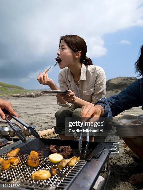 the woman who eats roast meat with good appetite - asian person bbq stock pictures, royalty-free photos & images