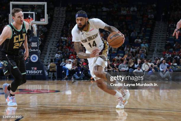 Brandon Ingram of the New Orleans Pelicans dribbles the ball during the game against the Charlotte Hornets on March 23, 2023 at the Smoothie King...