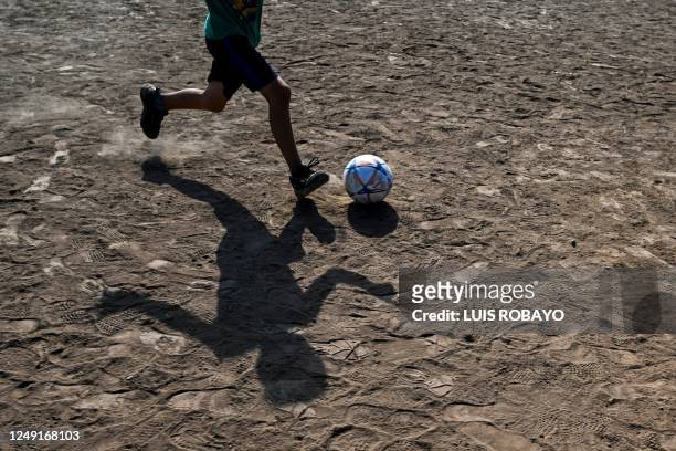 Boy plays soccer in the Los Pumitas neighbourhood in Rosario, Santa Fe province, Argentina, on March 15, 2023. - Rosario, Argentina's second city...