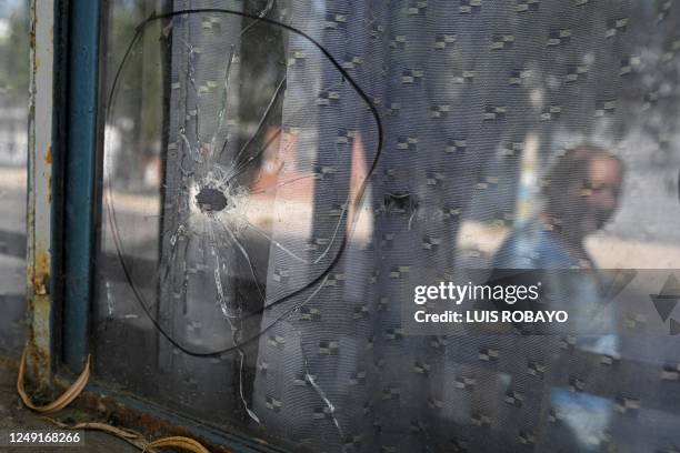 Shot hole is seen in a window of a house in the Los Pumitas neighbourhood in Rosario, Santa Fe province, Argentina, on March 15, 2023. - Rosario,...