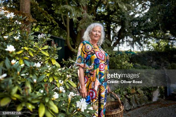 portrait of confident senior woman in garden - senior women gardening stock pictures, royalty-free photos & images